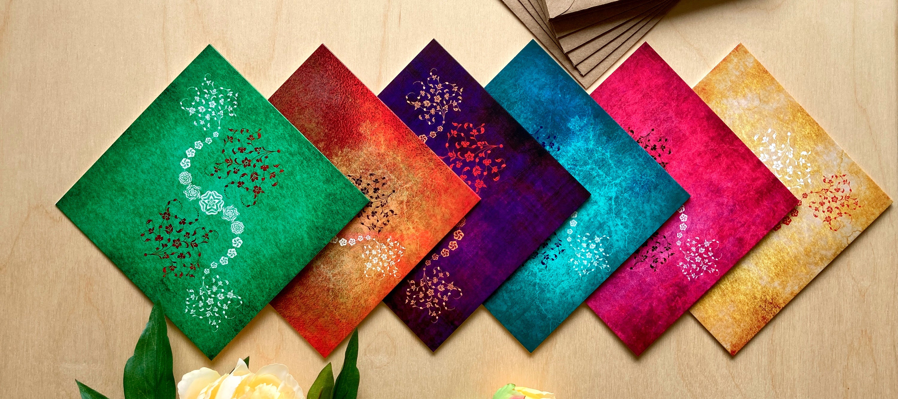 Colourful greeting cards with decorative floral  patterns on a wooden surface