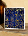 Square, blue and gold christmas card with ornamental pattern and white border
