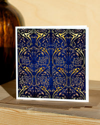 Square, blue and gold christmas card with ornamental pattern and white border