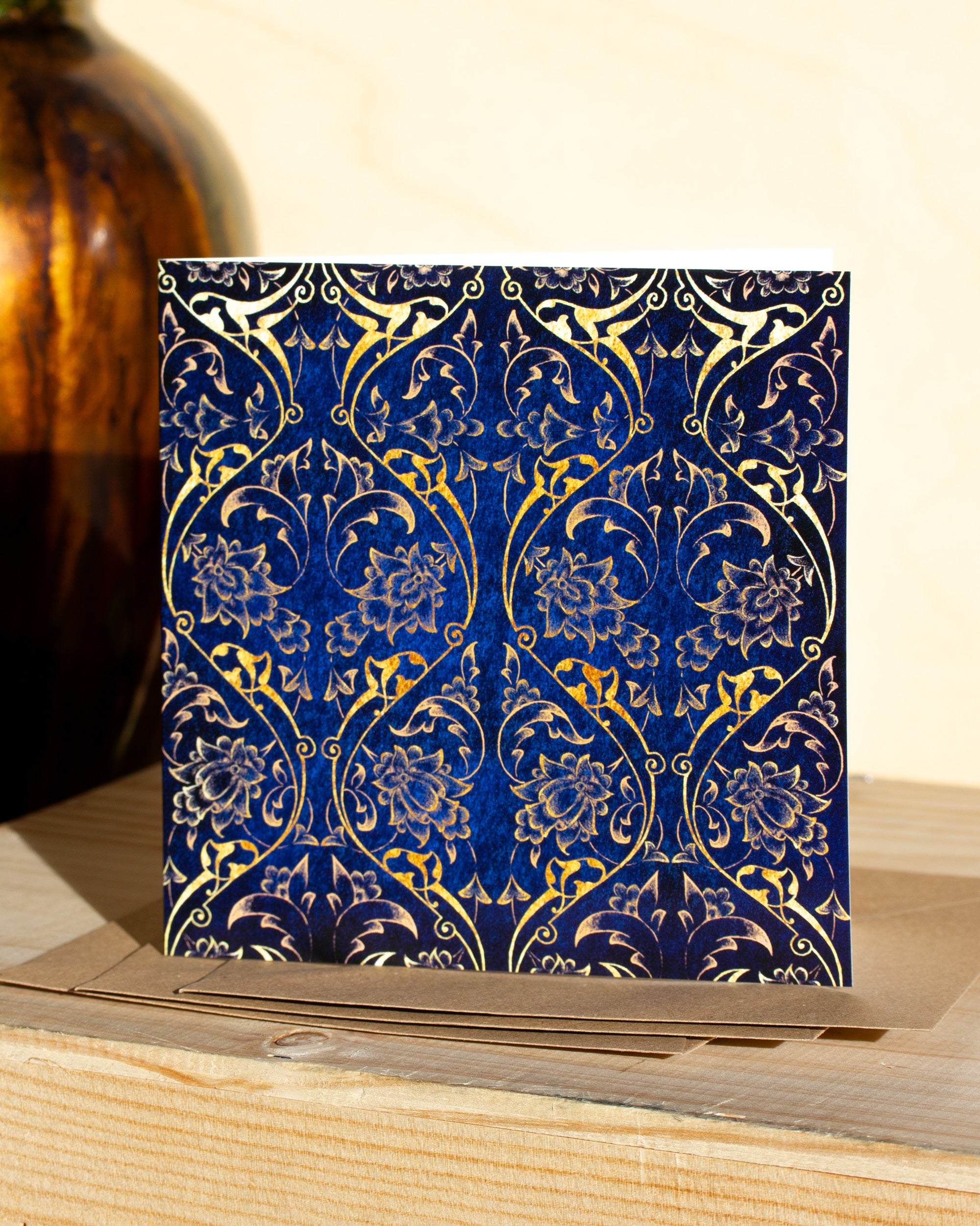 Square, blue and gold christmas card with ornamental pattern