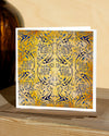 Square, yellow and blue christmas card with ornamental pattern and white border