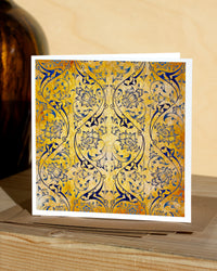 Square, yellow and blue christmas card with ornamental pattern and white border