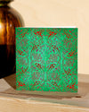Square, green and red christmas card with ornamental pattern