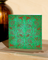 Square, green and red christmas card with ornamental pattern