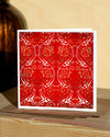 Square, red and white christmas card with ornamental pattern and white border