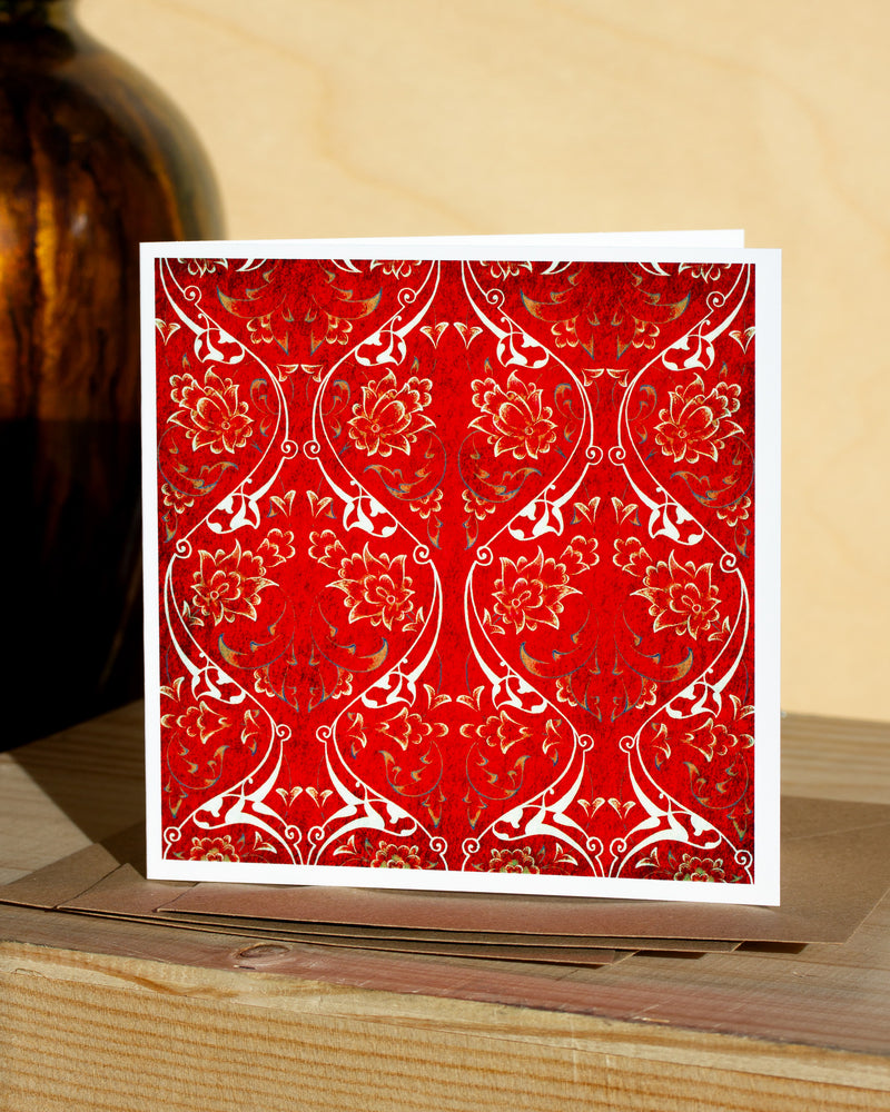 Square, red and white christmas card with ornamental pattern and white border